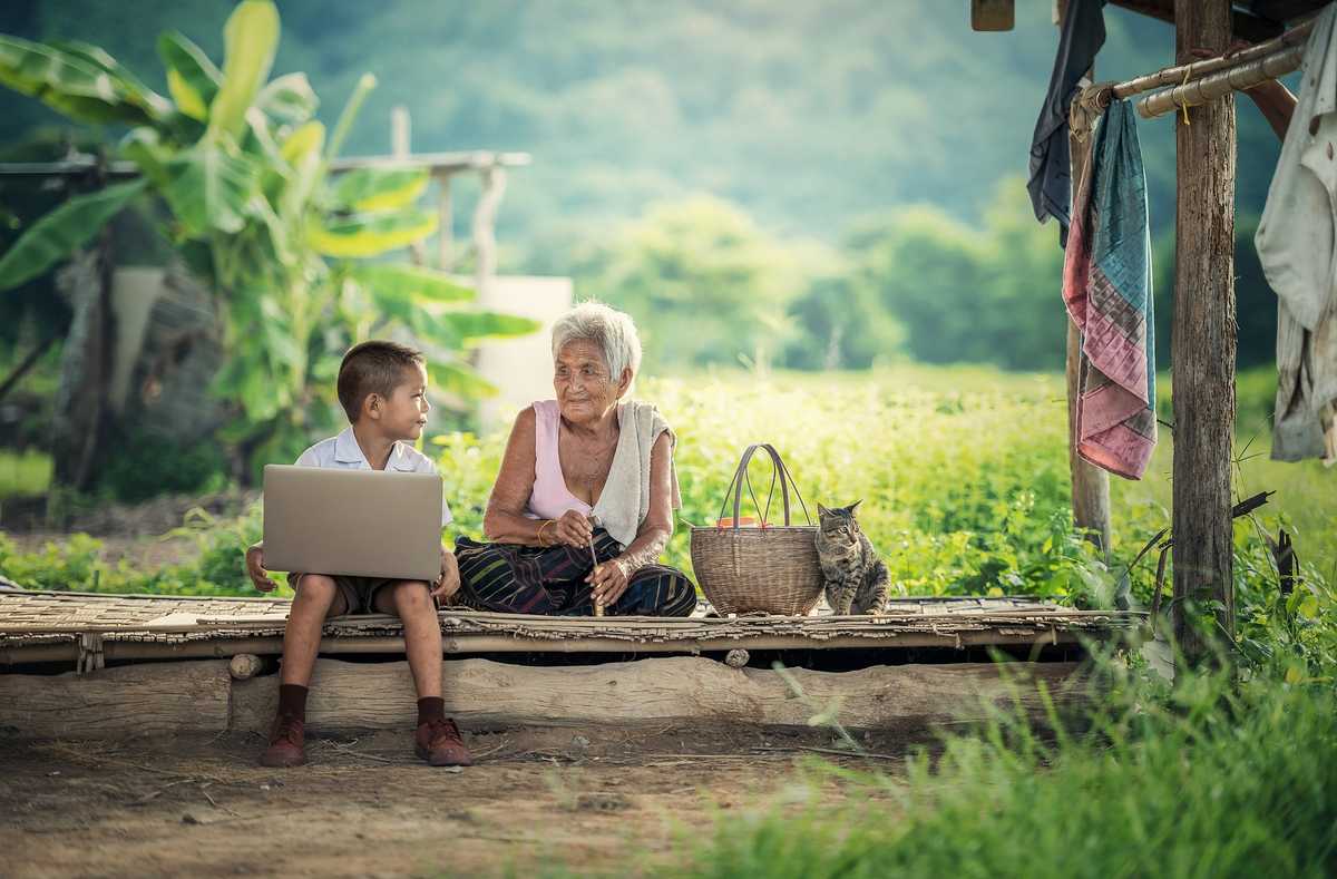 A child learning from his grandmother